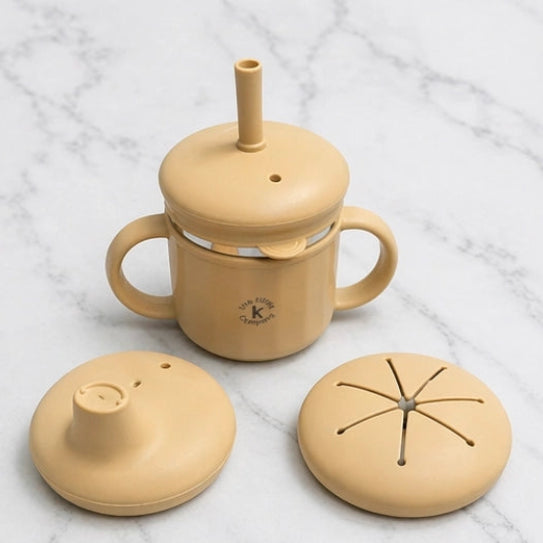Tan ceramic mug with various lids on a marble surface