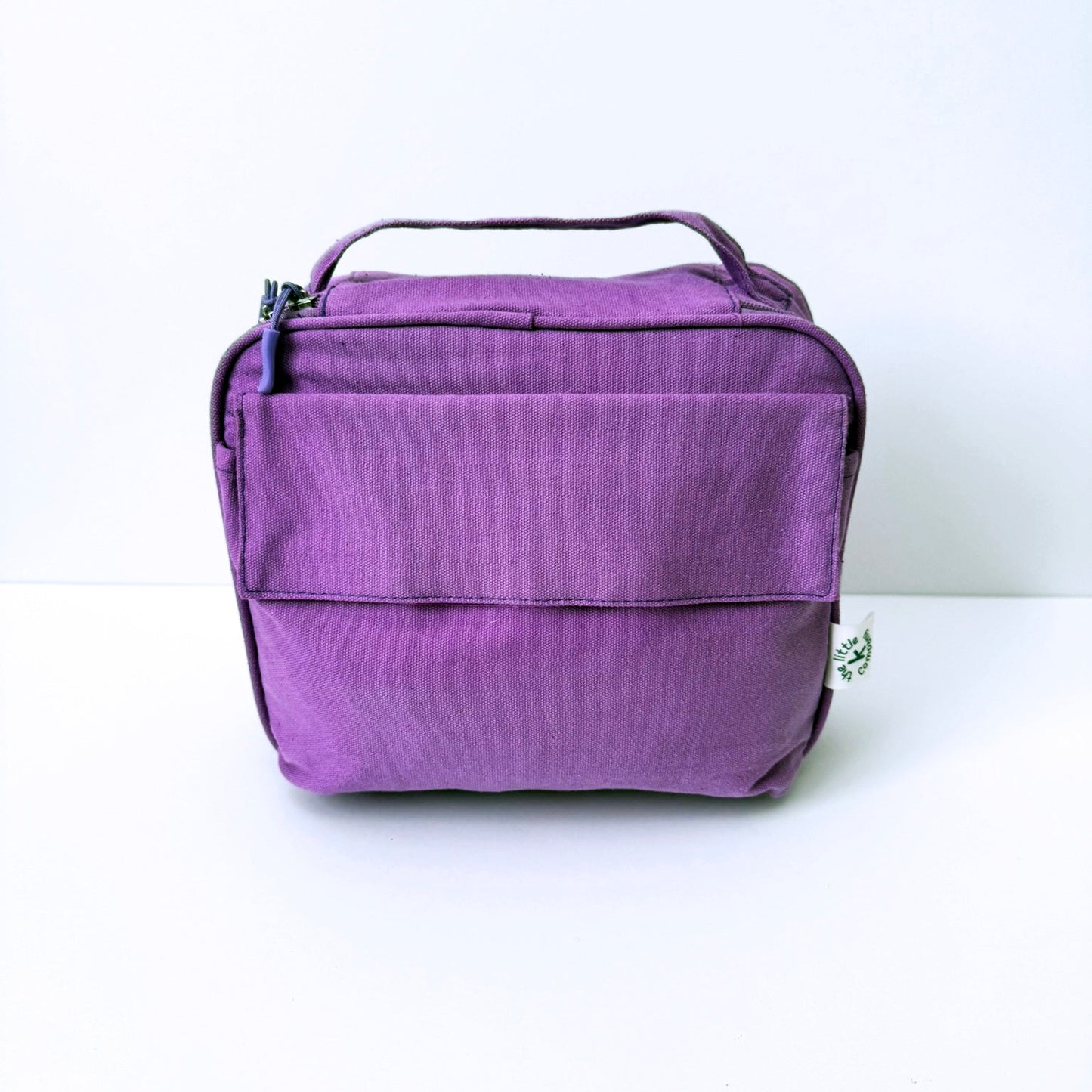 A purple GOTS certified organic cotton lunch bag with a top handle, shown against a plain white background.